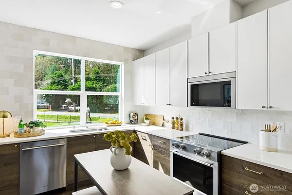 a kitchen with a stove a sink and a microwave