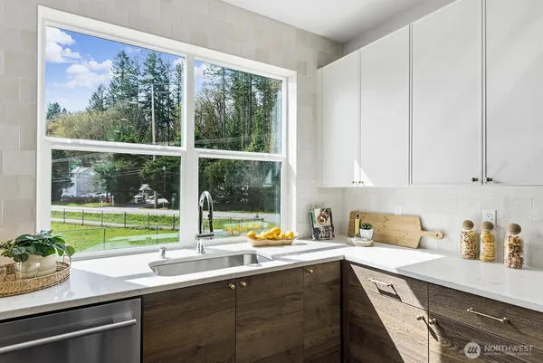 a kitchen with a sink and large window