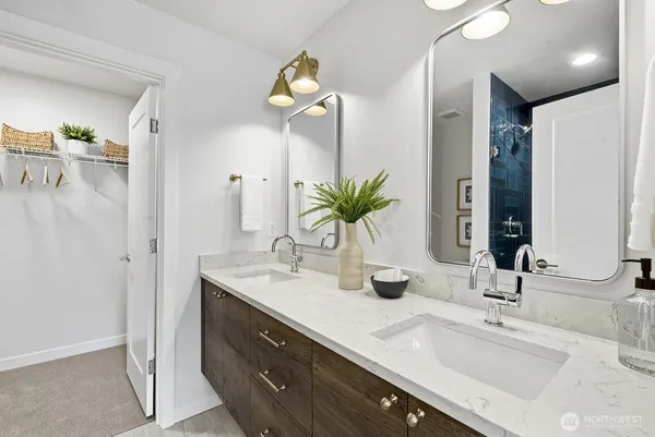 a bathroom with a double vanity sink and a mirror