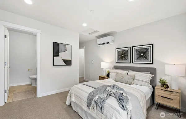 a bedroom with a bed and a painting