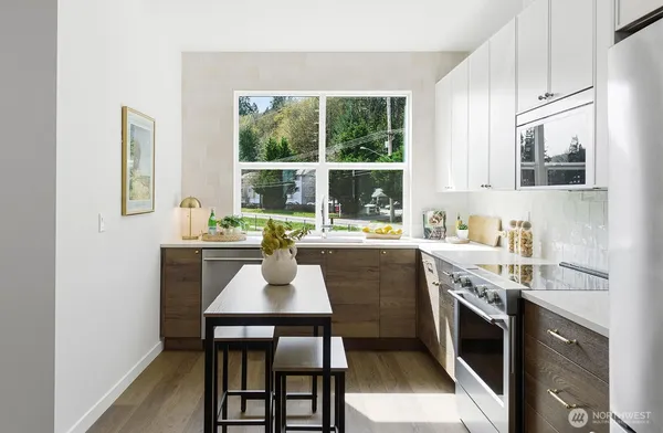 a kitchen with a stove a sink and a refrigerator