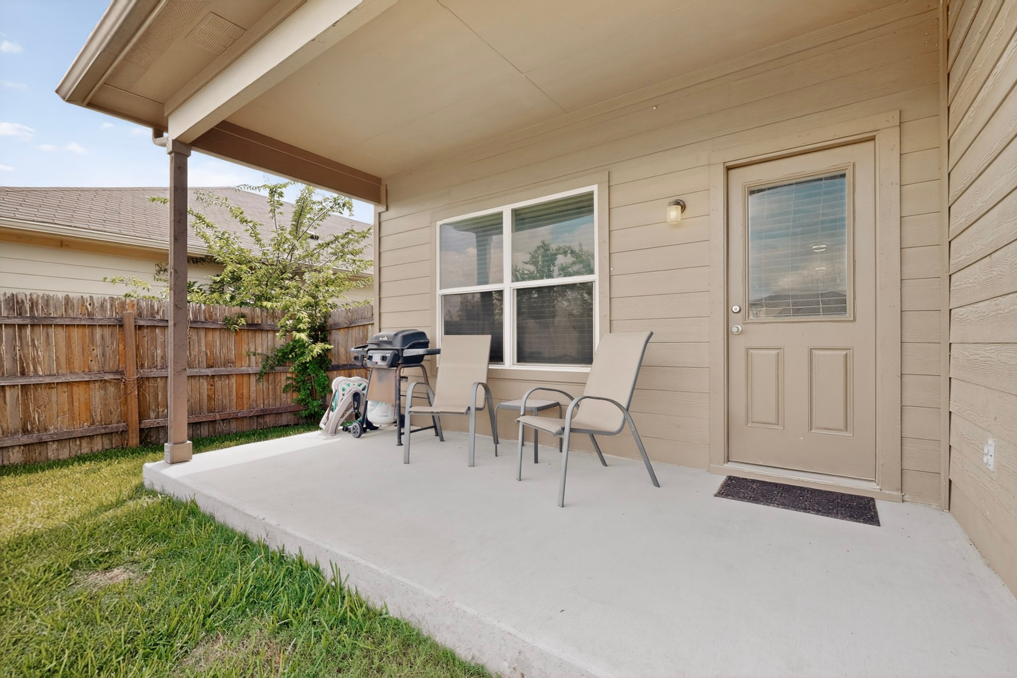14513 Esker Road Manor, TX 78653 - Photo 31 of 38 A private covered patio and ample fenced yard offer a relaxed outdoor retreat.