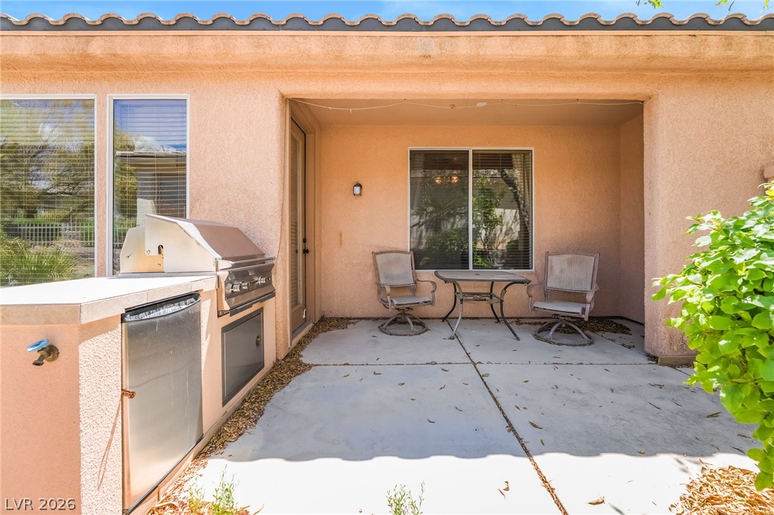 5389 Progresso Street Las Vegas, NV 89135 - Photo 26 of 41 A built-in barbecue and outdoor seating define this inviting covered patio.