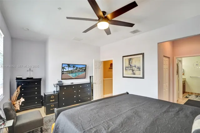 a bedroom with a bed and a tv