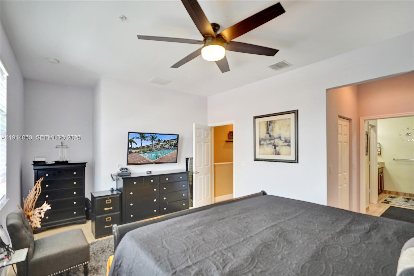 2659 Southwest 118 Road Miramar, FL 33025 - Photo 14 of 28 a bedroom with a bed and a tv