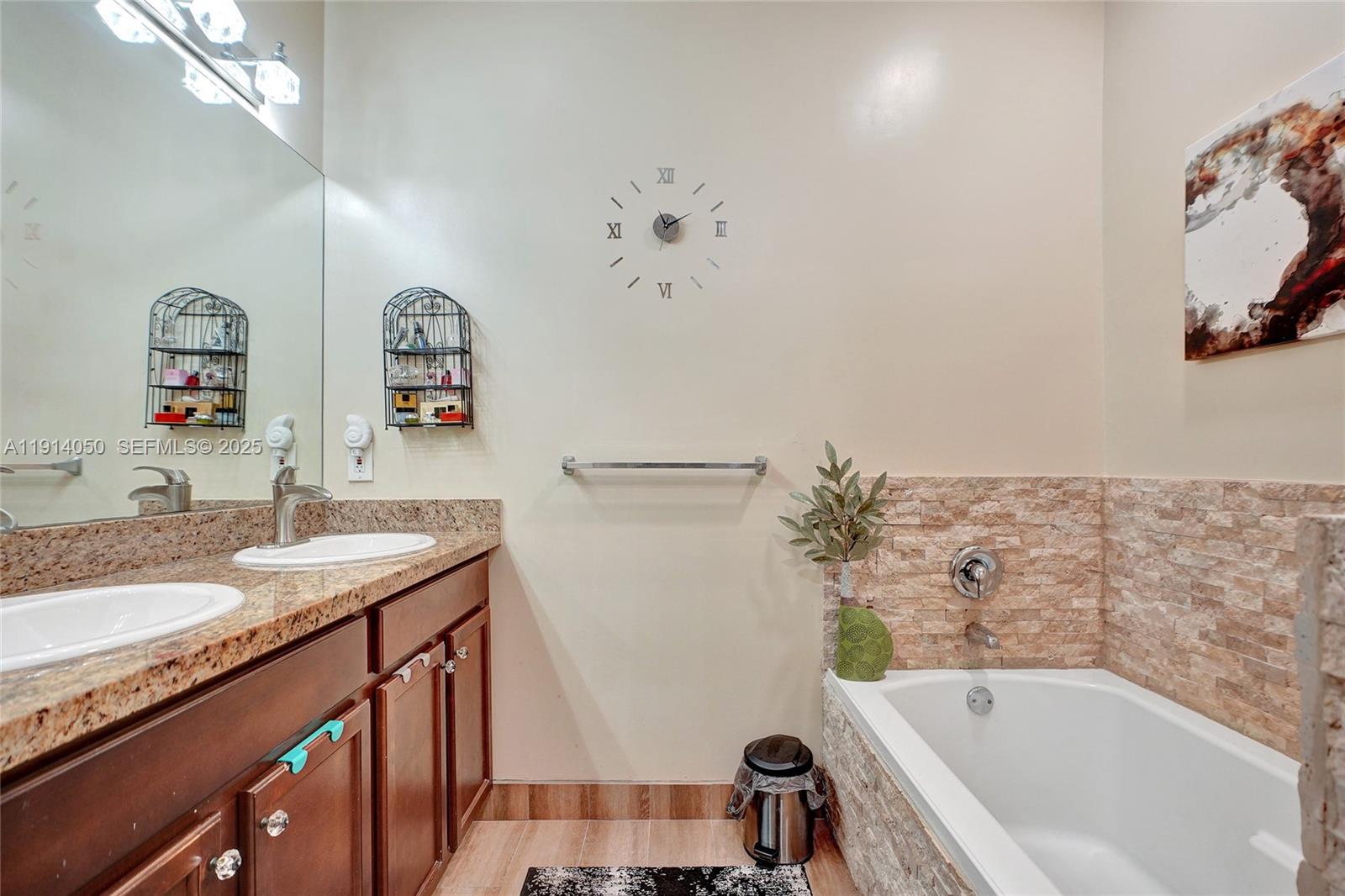 2659 Southwest 118 Road Miramar, FL 33025 - Photo 15 of 28 a bathroom with a granite countertop sink a bathtub and a shower