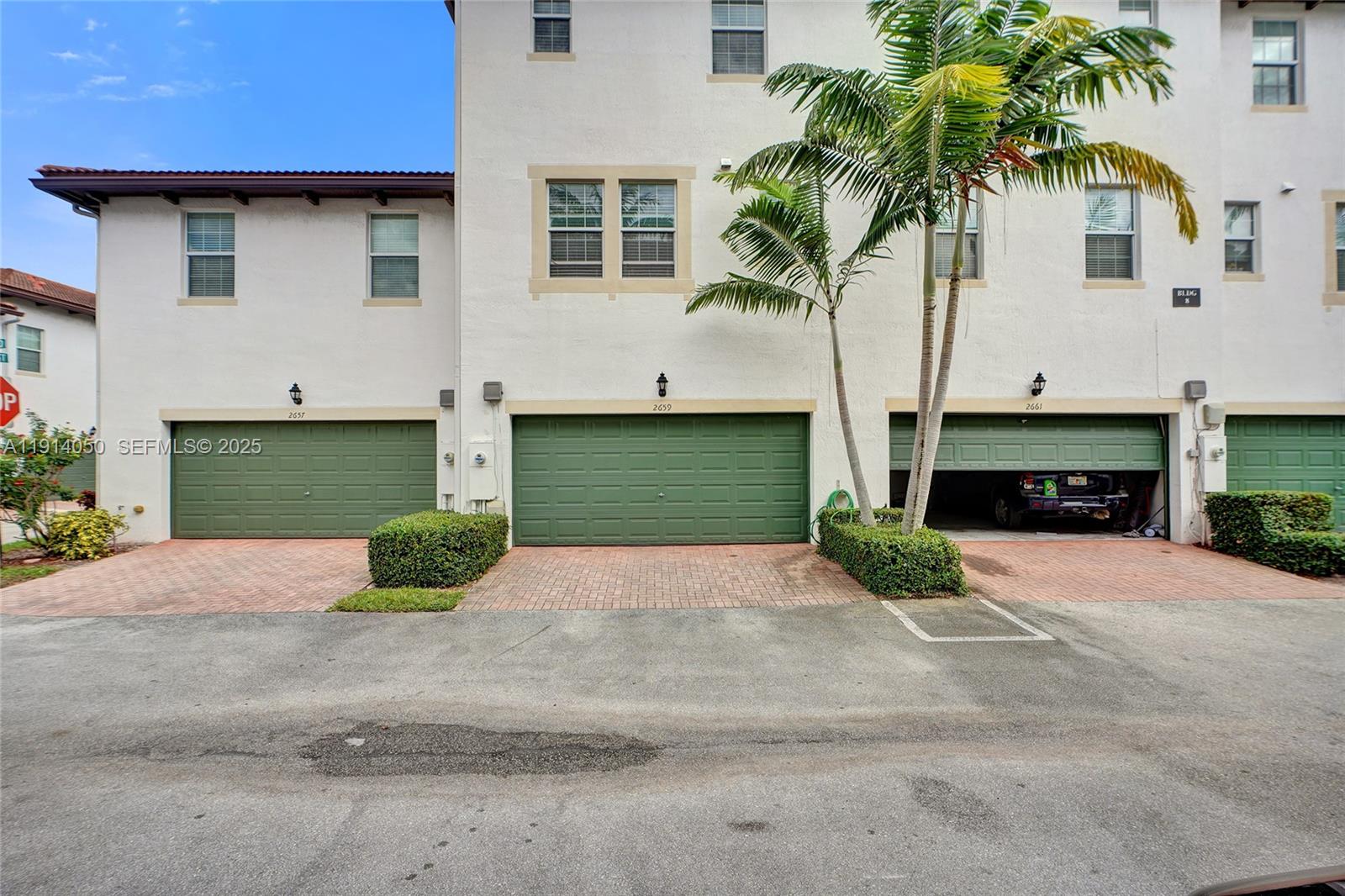 2659 Southwest 118 Road Miramar, FL 33025 - Photo 27 of 28 a front view of a house with a yard and garage
