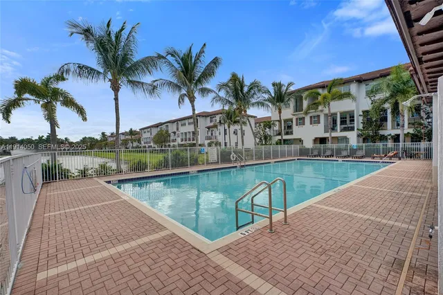 a view of swimming pool with outdoor seating and plants