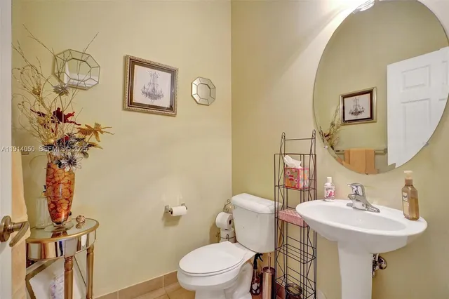 a bathroom with a sink mirror vanity and toilet