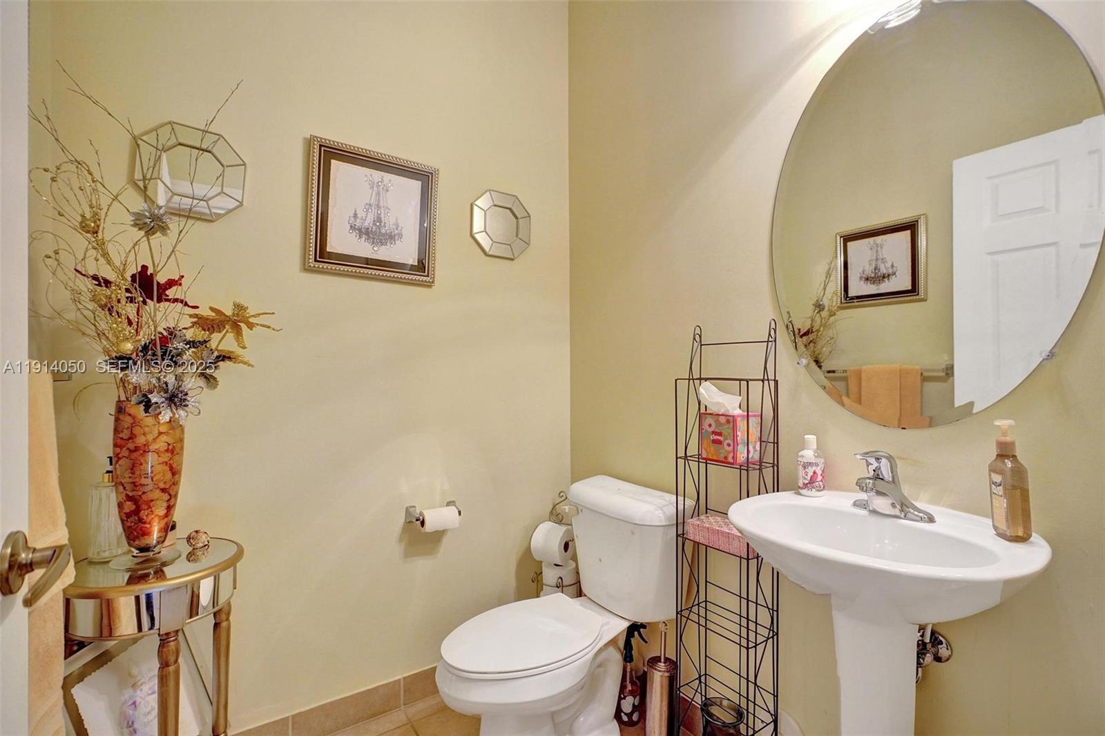 2659 Southwest 118 Road Miramar, FL 33025 - Photo 9 of 28 a bathroom with a sink mirror vanity and toilet