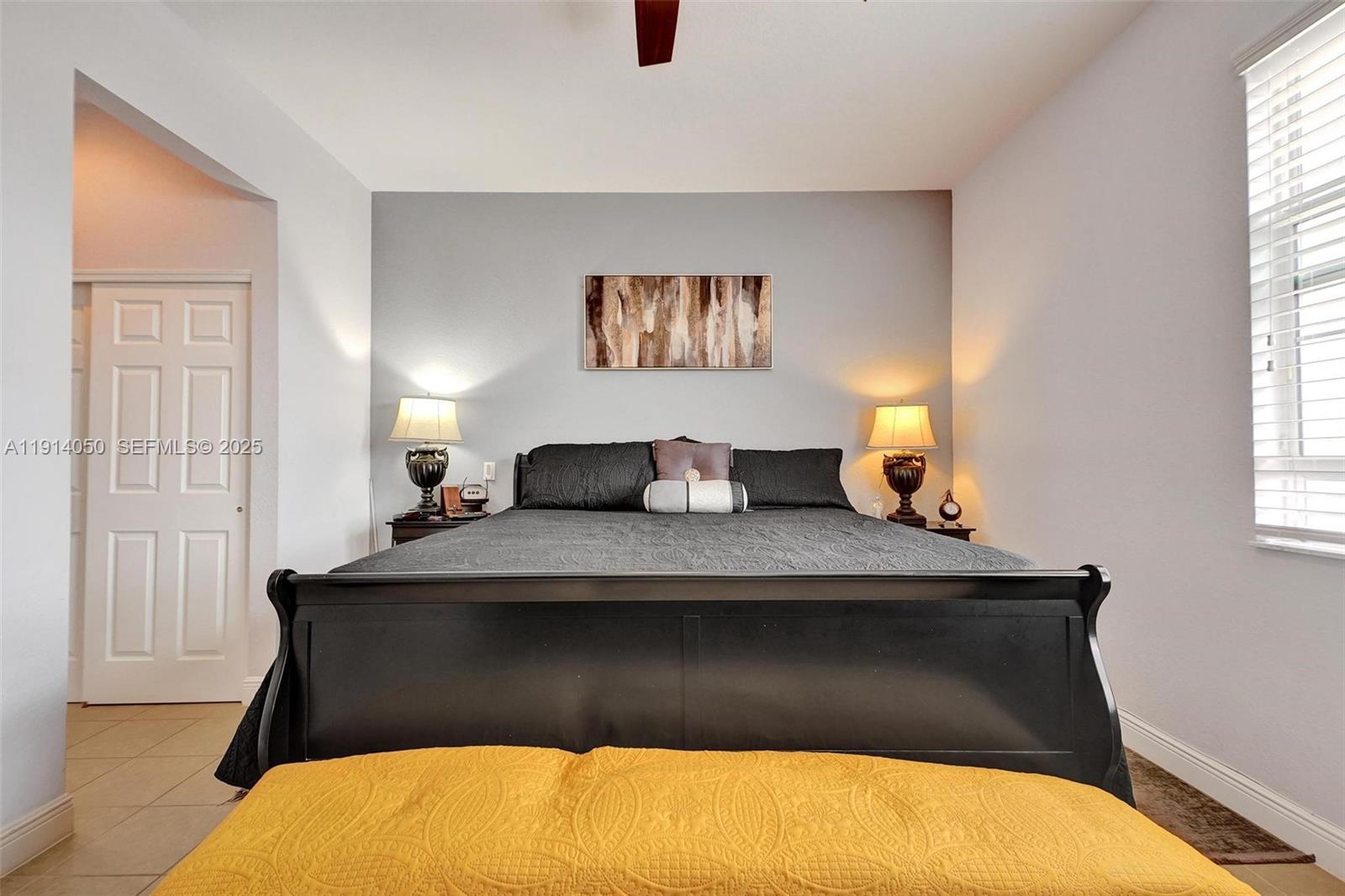 2659 Southwest 118 Road Miramar, FL 33025 - Photo 10 of 28 a bedroom with a bed and window