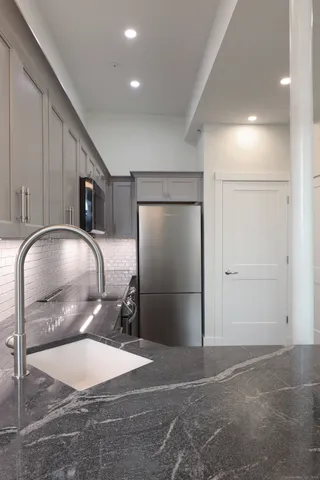 a kitchen with a refrigerator a stove and cabinets