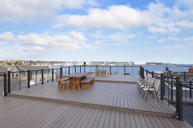 a view of a roof deck with patio
