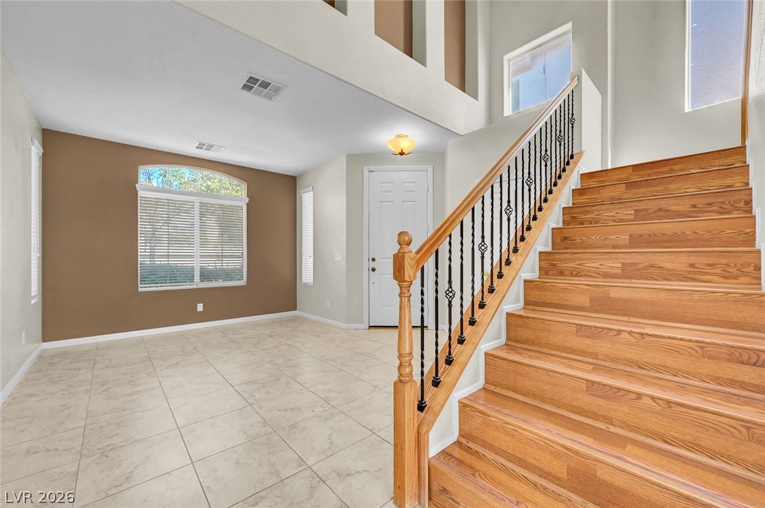 977 Sparkling Light Street Henderson, NV 89052 - Photo 3 of 75 This inviting interior features a grand staircase and abundant natural light.