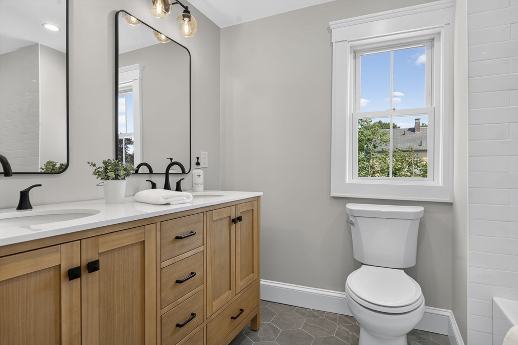 20 Saltonstall Road Medford, MA 02155 - Photo 31 of 41 a bathroom with a toilet a sink a mirror and a window