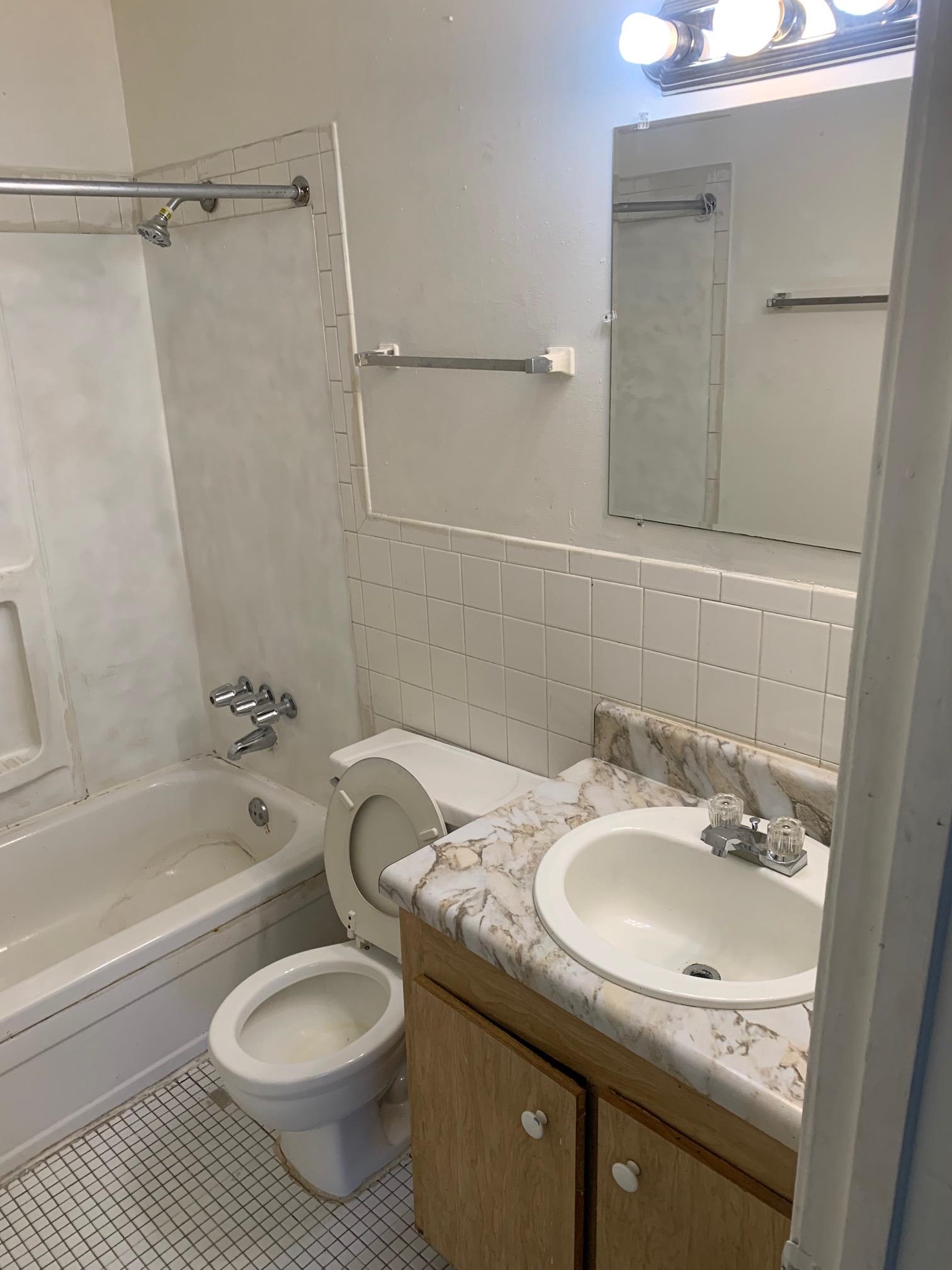 677 Miles, Unit 677 Memphis, TN 38111 - Photo 11 of 17 a bathroom with a granite countertop sink toilet and shower