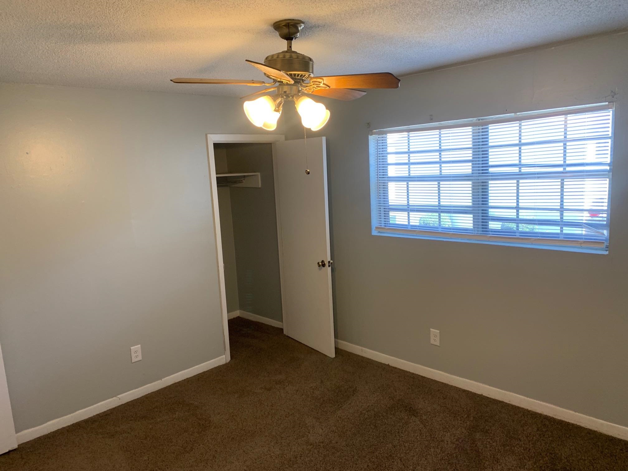 677 Miles, Unit 677 Memphis, TN 38111 - Photo 13 of 17 an empty room with chandelier fan and windows