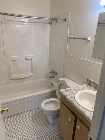 a bathroom with a granite countertop sink toilet a shower and a mirror