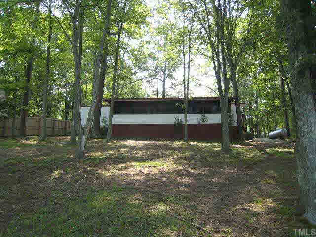 311 Kerr Lake Road Henderson, NC 27537 - Photo 2 of 10 a view of a yard with a tree