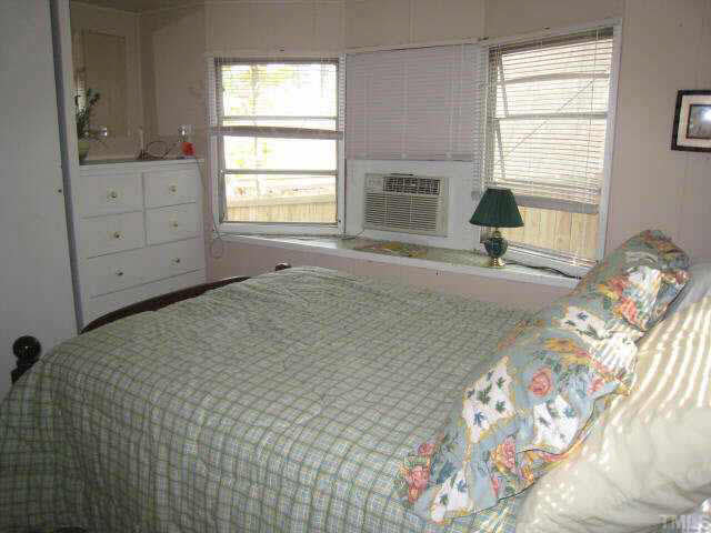 311 Kerr Lake Road Henderson, NC 27537 - Photo 6 of 10 a spacious bedroom with a bed and a window