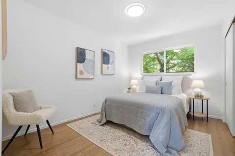 a bedroom with a bed and a chair