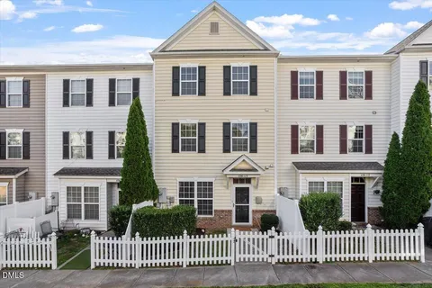 a front view of a house with a fence