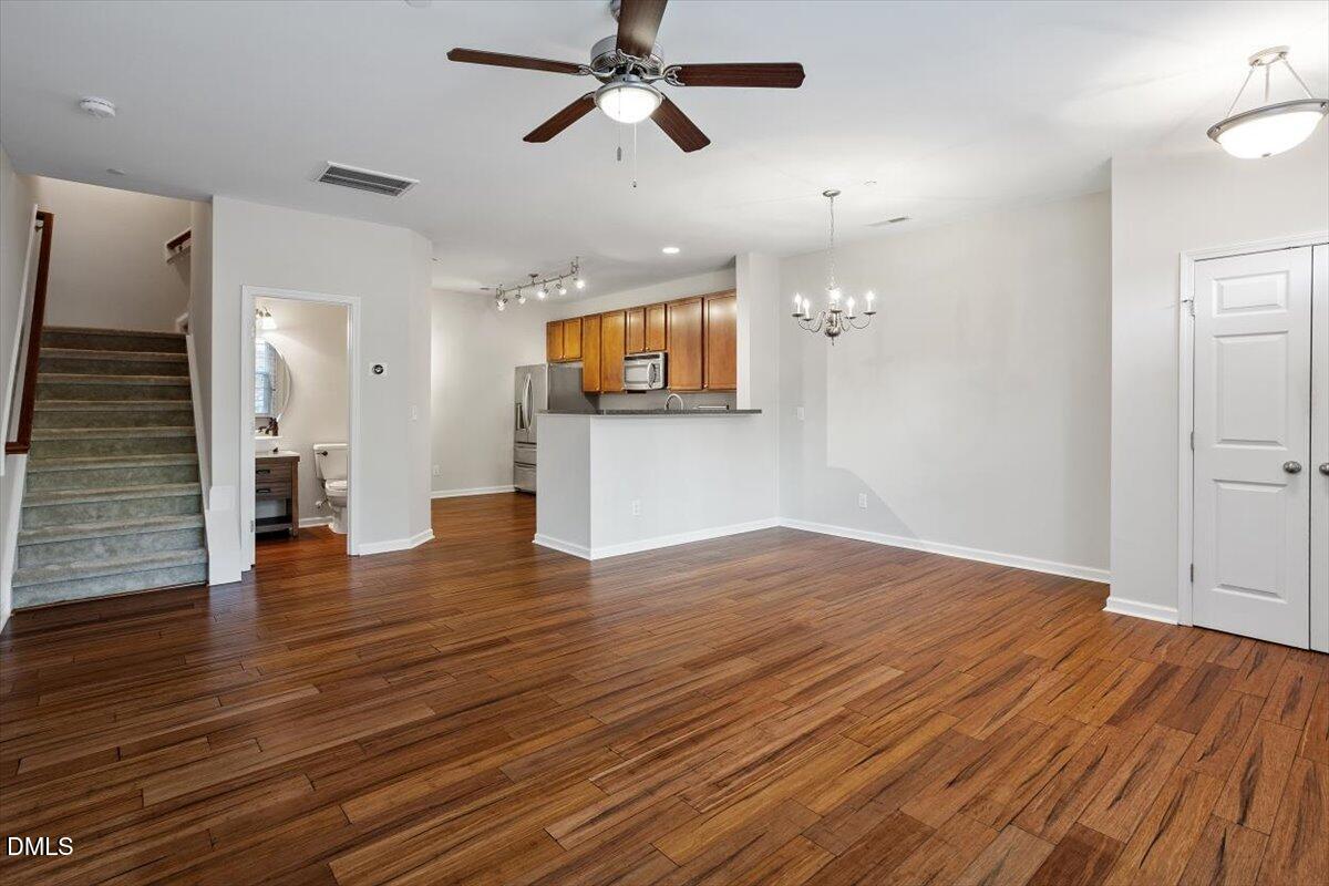 1120 Renewal Place, Unit 113 Raleigh, NC 27603 - Photo 10 of 38 an empty room with wooden floor and windows