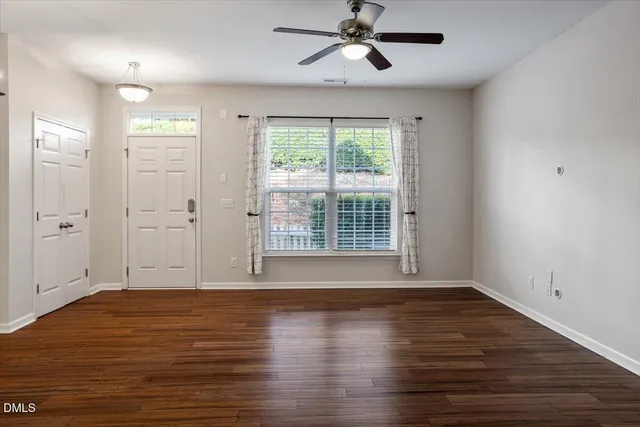 a view of a livingroom with a ceiling fan and window