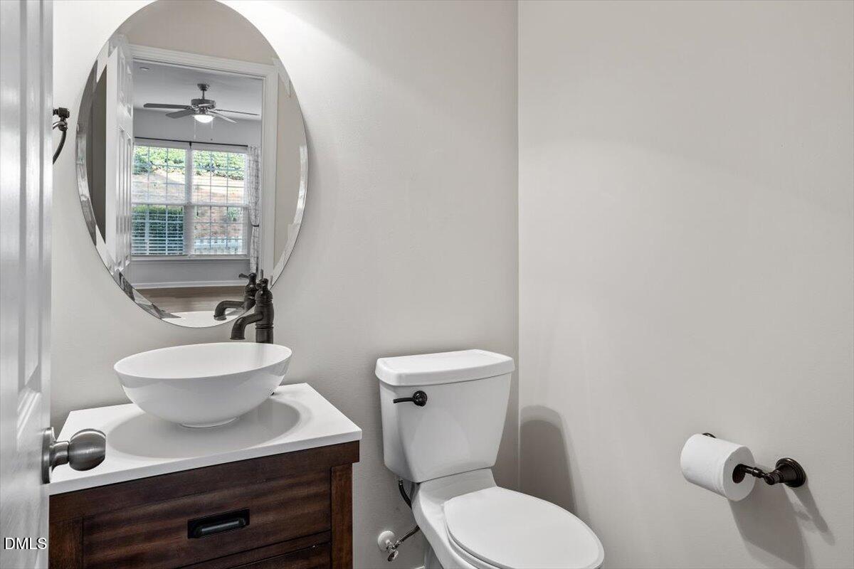 1120 Renewal Place, Unit 113 Raleigh, NC 27603 - Photo 15 of 38 a bathroom with a toilet a sink and mirror