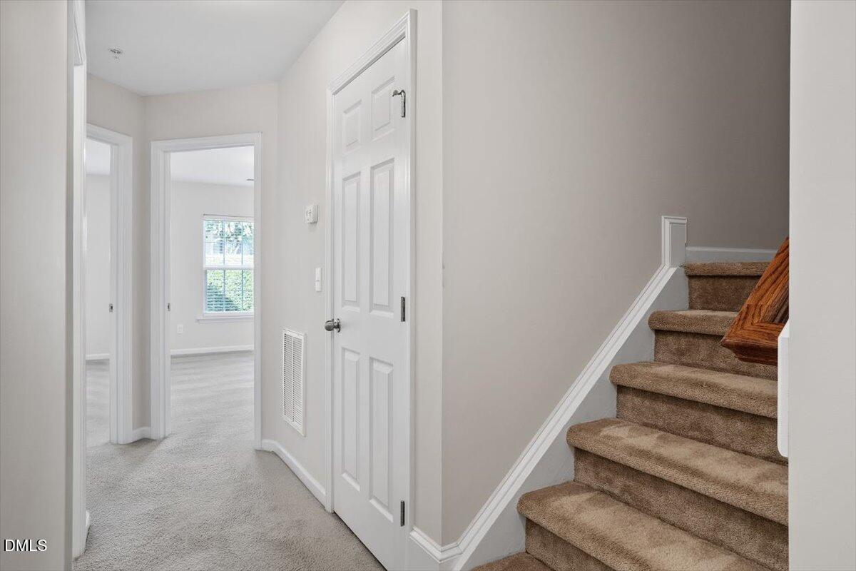 1120 Renewal Place, Unit 113 Raleigh, NC 27603 - Photo 17 of 38 a view of a hallway with wooden floor and entryway