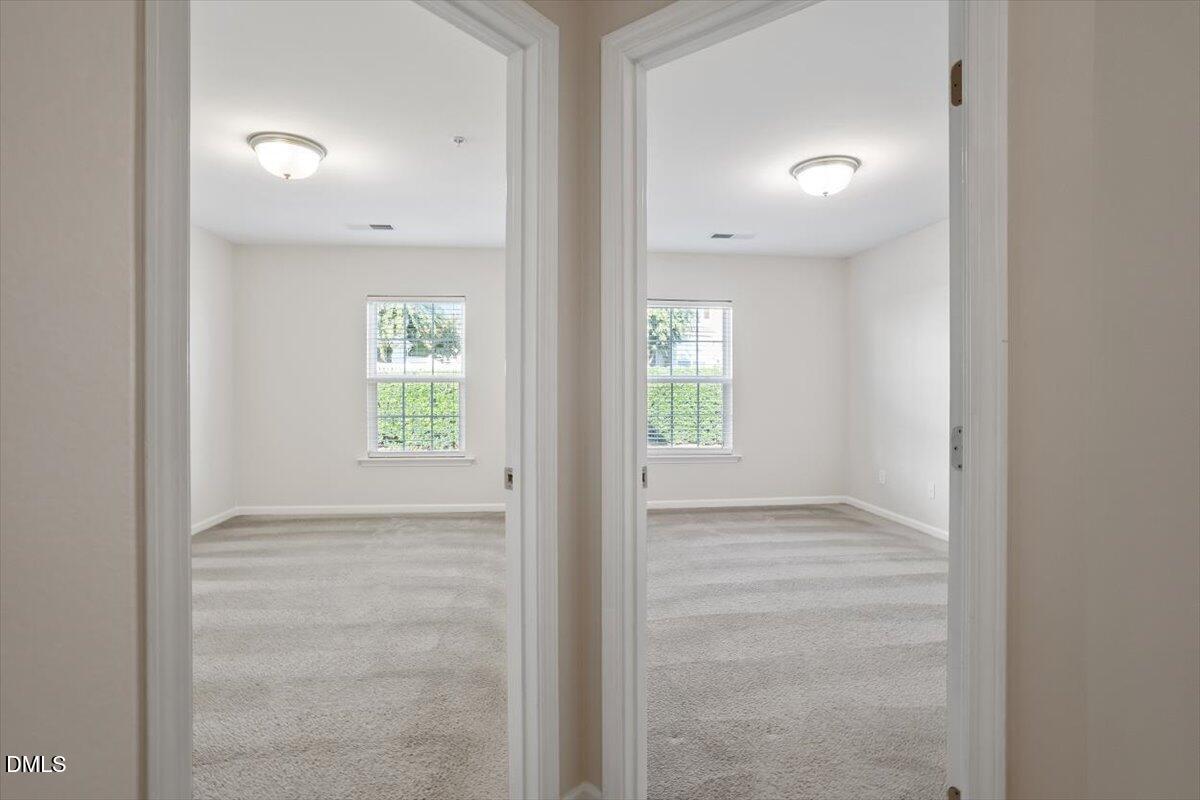 1120 Renewal Place, Unit 113 Raleigh, NC 27603 - Photo 19 of 38 an empty room with windows and closet