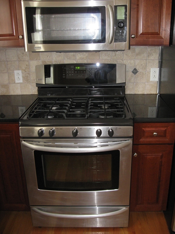 2856 Washington Street Boston, MA 02119 - Photo 37 of 39 a stove top oven sitting inside of a kitchen