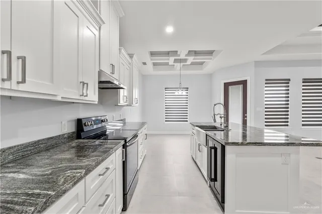 a kitchen with stainless steel appliances granite countertop a sink stove and cabinets