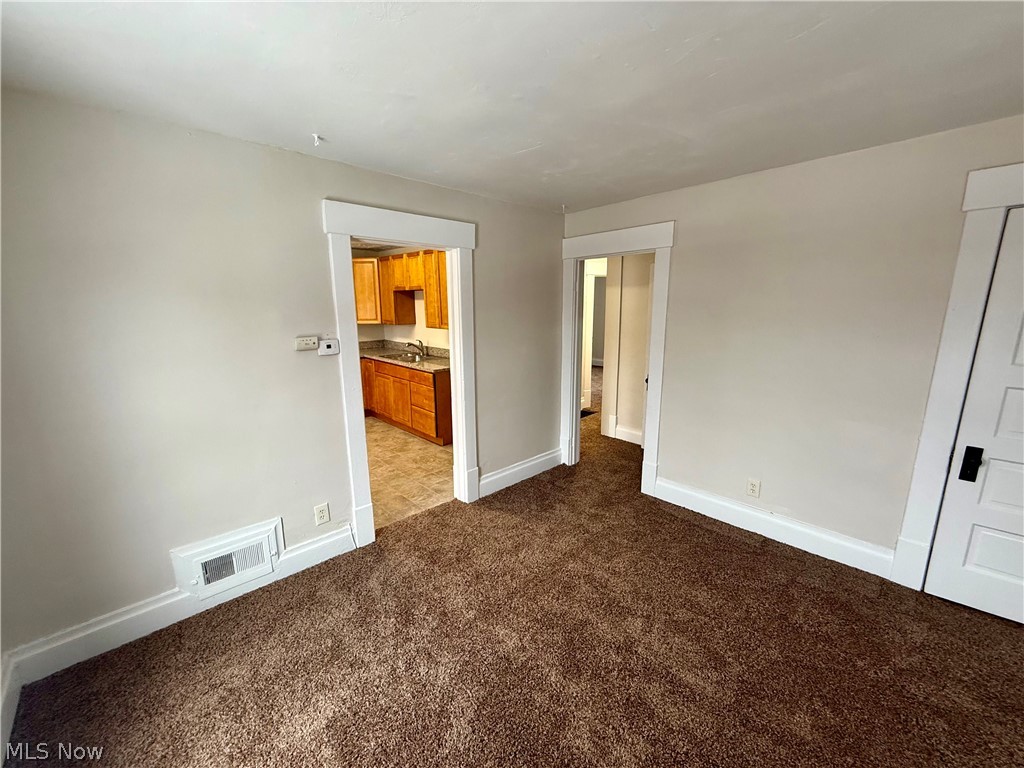 39 North Balch Street Akron, OH 44303 - Photo 8 of 19 Unfurnished bedroom with dark colored carpet and baseboards
