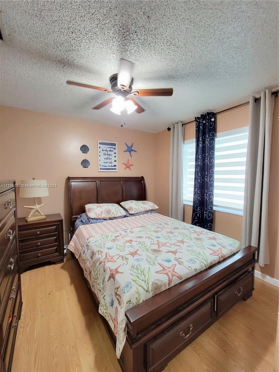 12989 Southwest 251st Terrace Homestead, FL 33032 - Photo 18 of 28 a bedroom with a bed and window