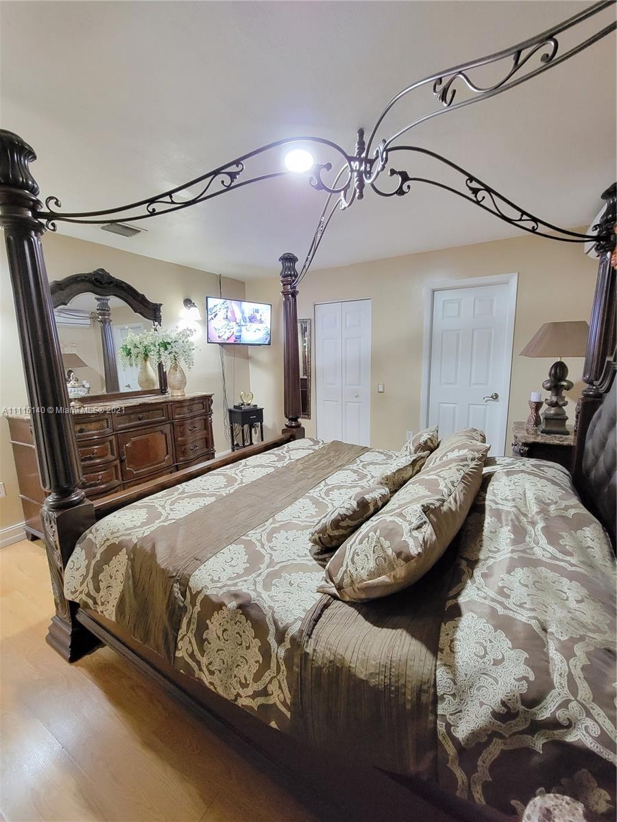 12989 Southwest 251st Terrace Homestead, FL 33032 - Photo 24 of 28 a bedroom with a bed and mirror