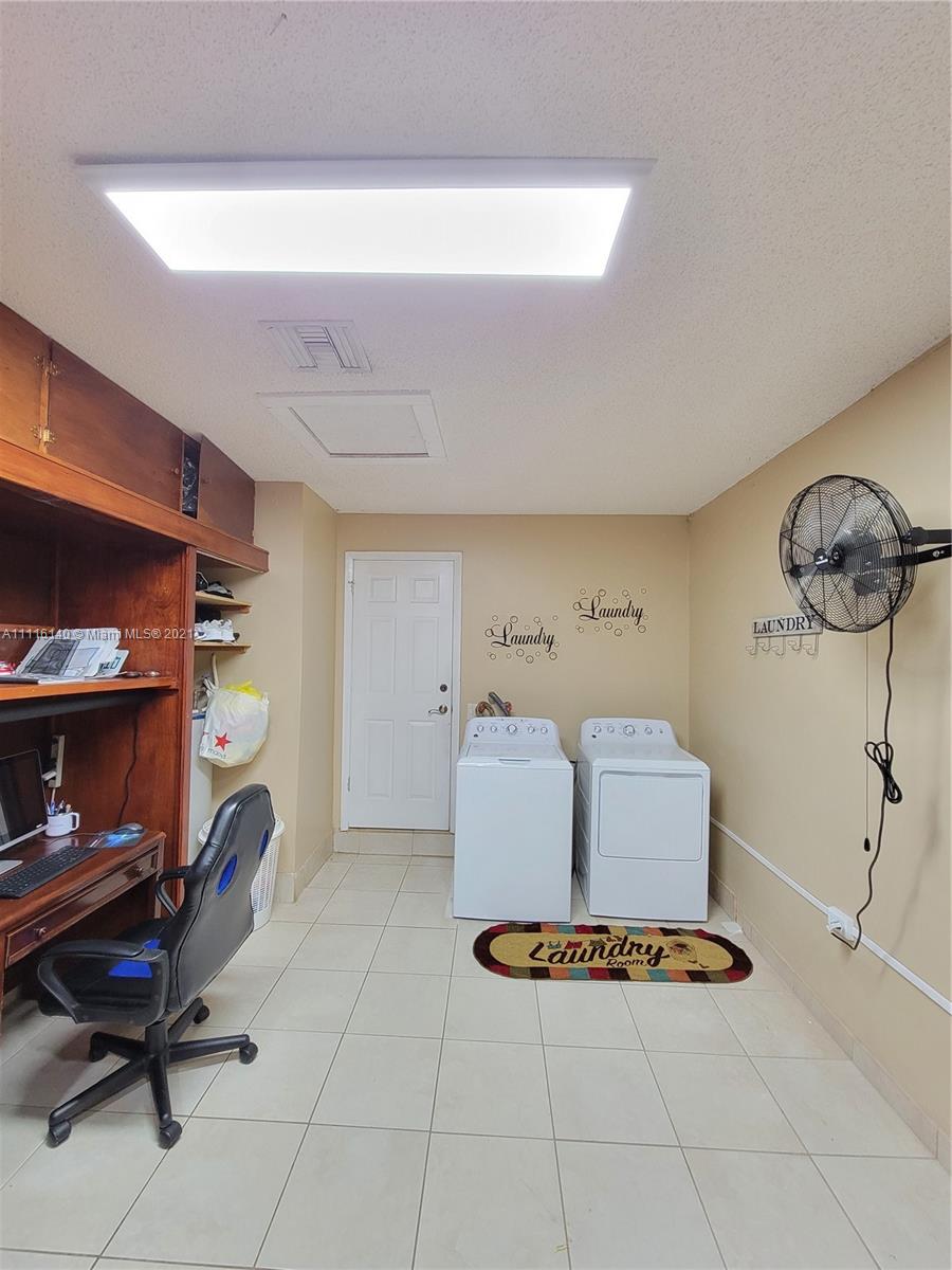 12989 Southwest 251st Terrace Homestead, FL 33032 - Photo 27 of 28 a living room with furniture gym equipment and a rug