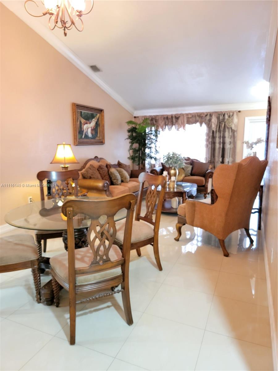 12989 Southwest 251st Terrace Homestead, FL 33032 - Photo 4 of 28 a living room with furniture and a large window