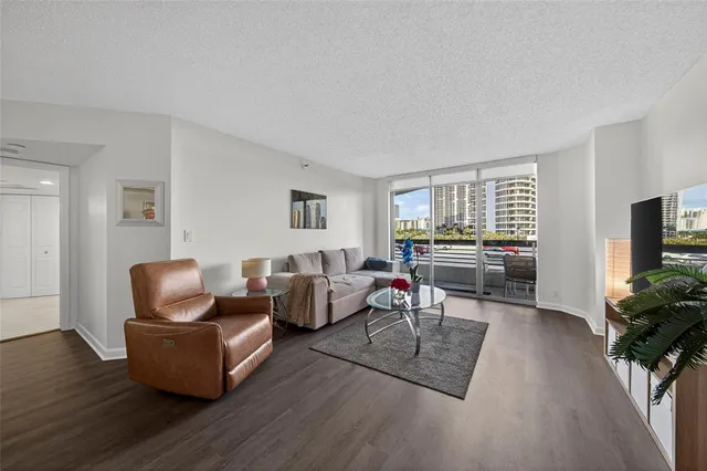 a living room with furniture rug and wooden floor