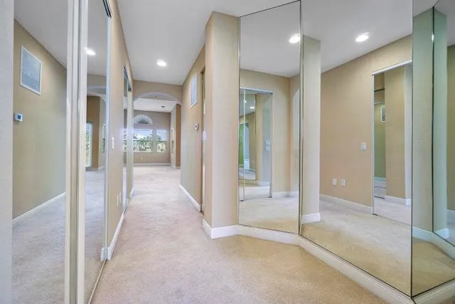 a spacious bathroom with a granite countertop tub a sink and a large mirror