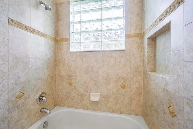 a bathroom with a double vanity sink toilet and shower