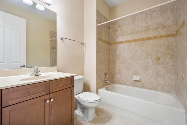 a bathroom with a sink a toilet a mirror and bathtub