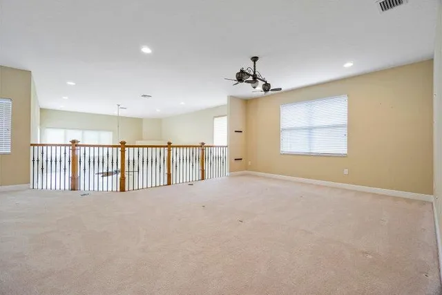 a view of a room with wooden floor and a window