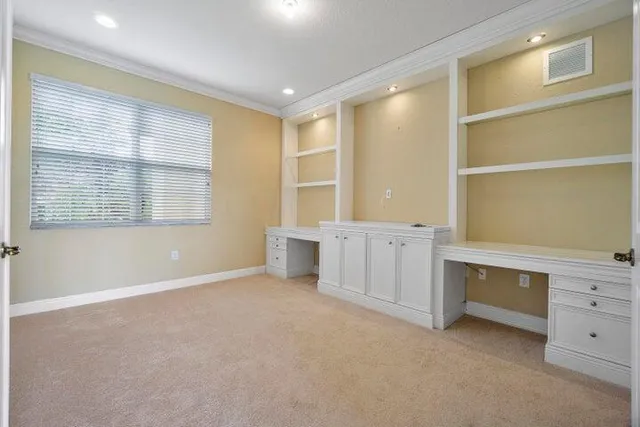 a room with a desk and window