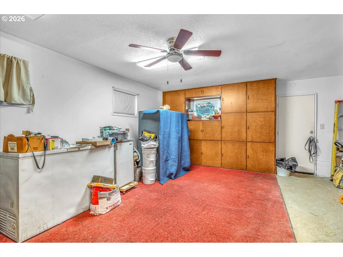 240 Northeast 80th Avenue Portland, OR 97213 - Photo 12 of 25 a bedroom with a bed and a chandelier