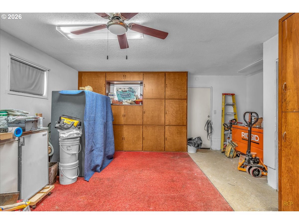 240 Northeast 80th Avenue Portland, OR 97213 - Photo 13 of 25 a bedroom with a bed and a chandelier