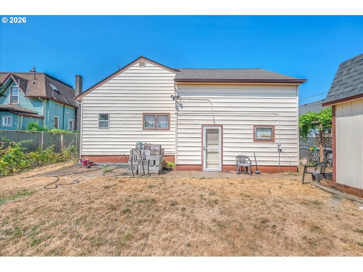 240 Northeast 80th Avenue Portland, OR 97213 - Photo 17 of 25 a view of a house with a backyard and a garage