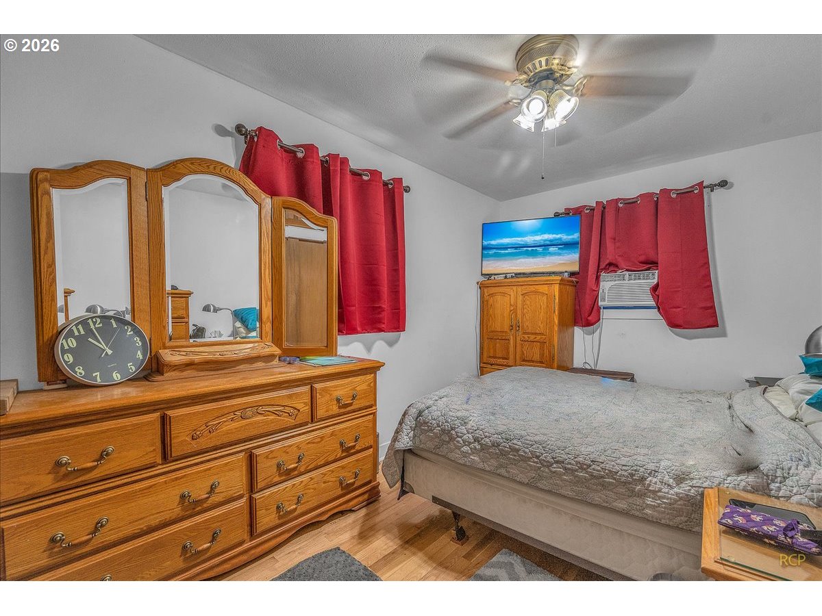 240 Northeast 80th Avenue Portland, OR 97213 - Photo 3 of 25 a bedroom with a bed and a dresser