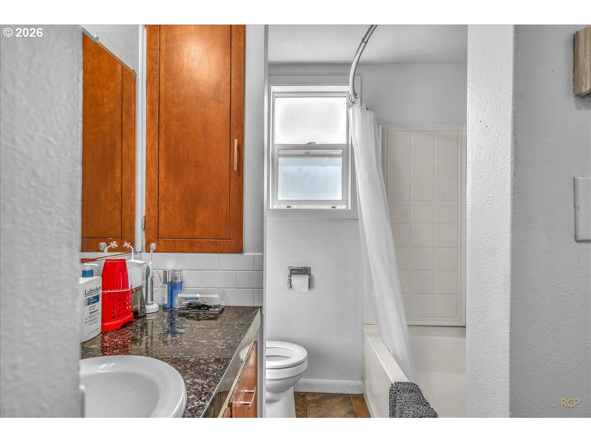 240 Northeast 80th Avenue Portland, OR 97213 - Photo 10 of 25 a bathroom with a granite countertop sink and a mirror