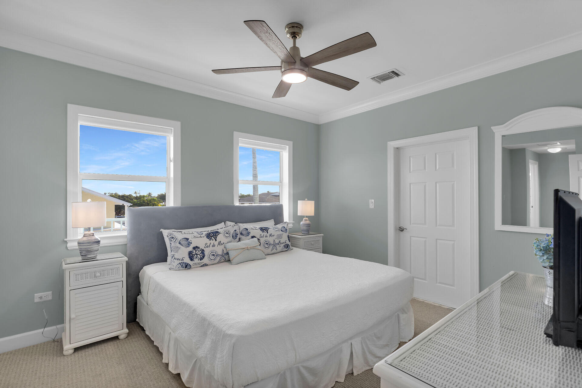 580-590 10th Street Key Colony Beach, FL 33051 - Photo 33 of 75 a bedroom with a large bed and a chandelier